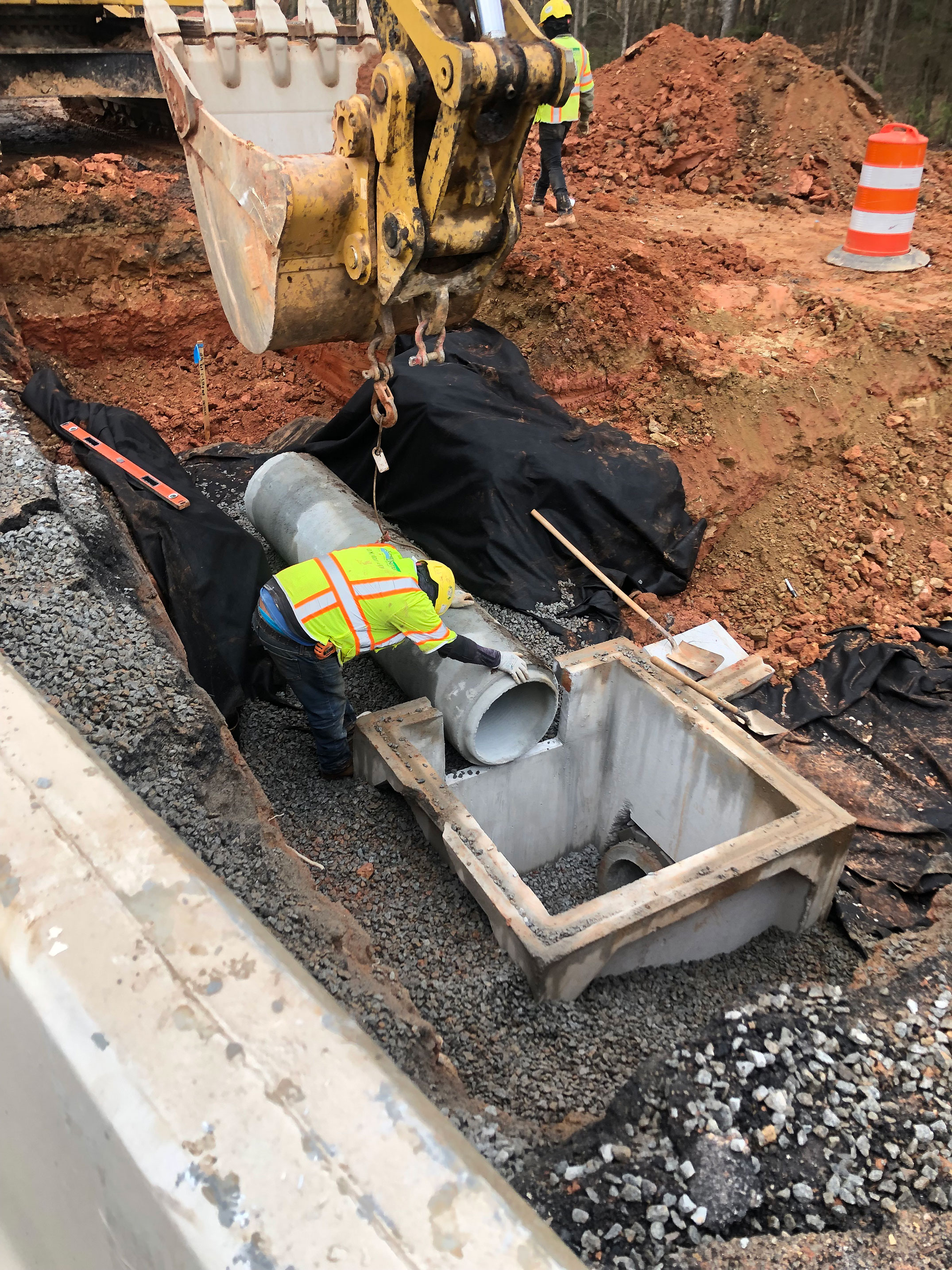 Catch basins are designed to connect the drainage systems and route the stormwater to an outlet.  Here crews are connecting perpendicular lines using a precast catch basin.