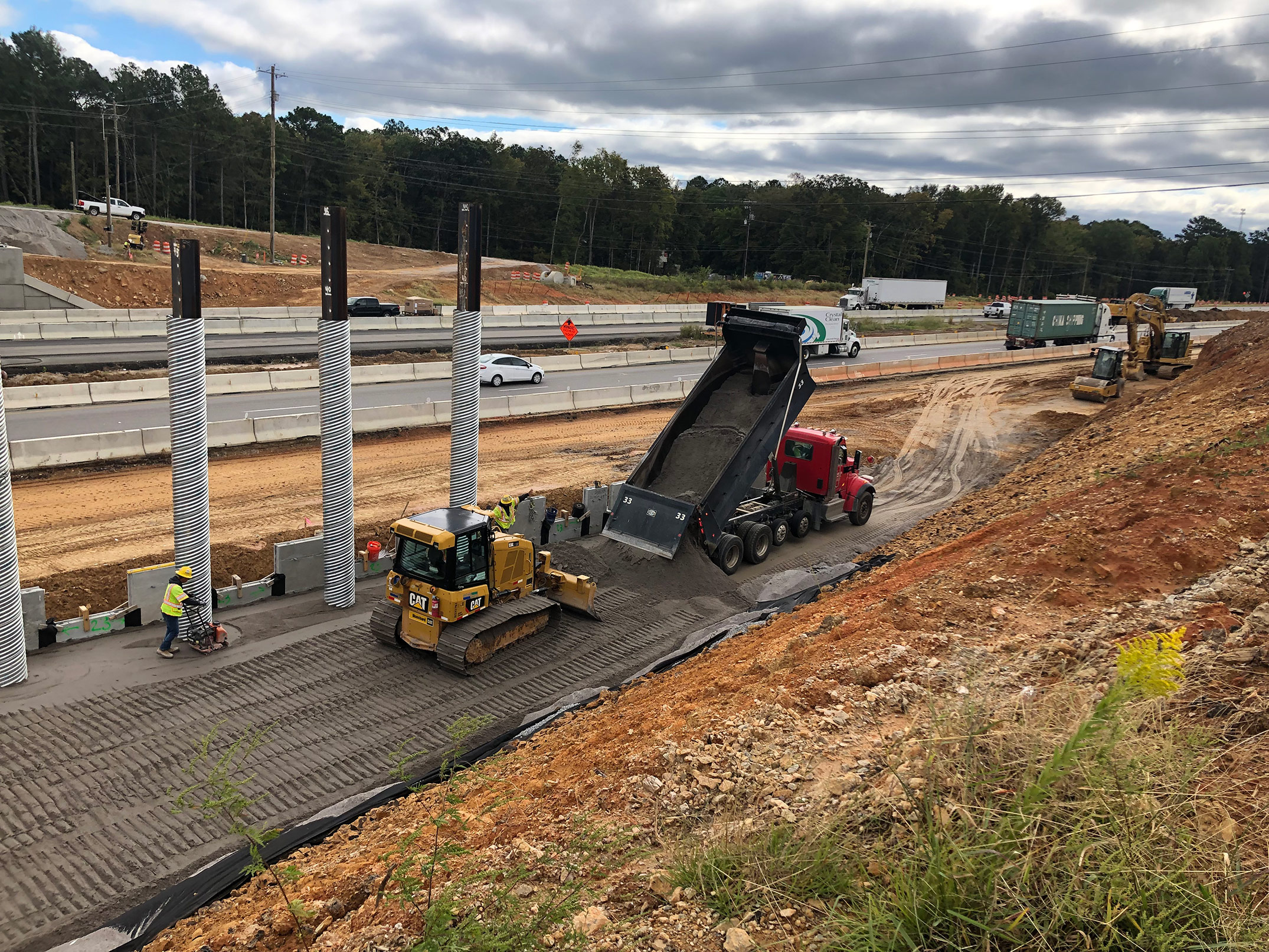 In this photo, crews are working on the Koon Road overpass bridge MSE wall on the Eastbound side. This is located in segment 1 of construction. 