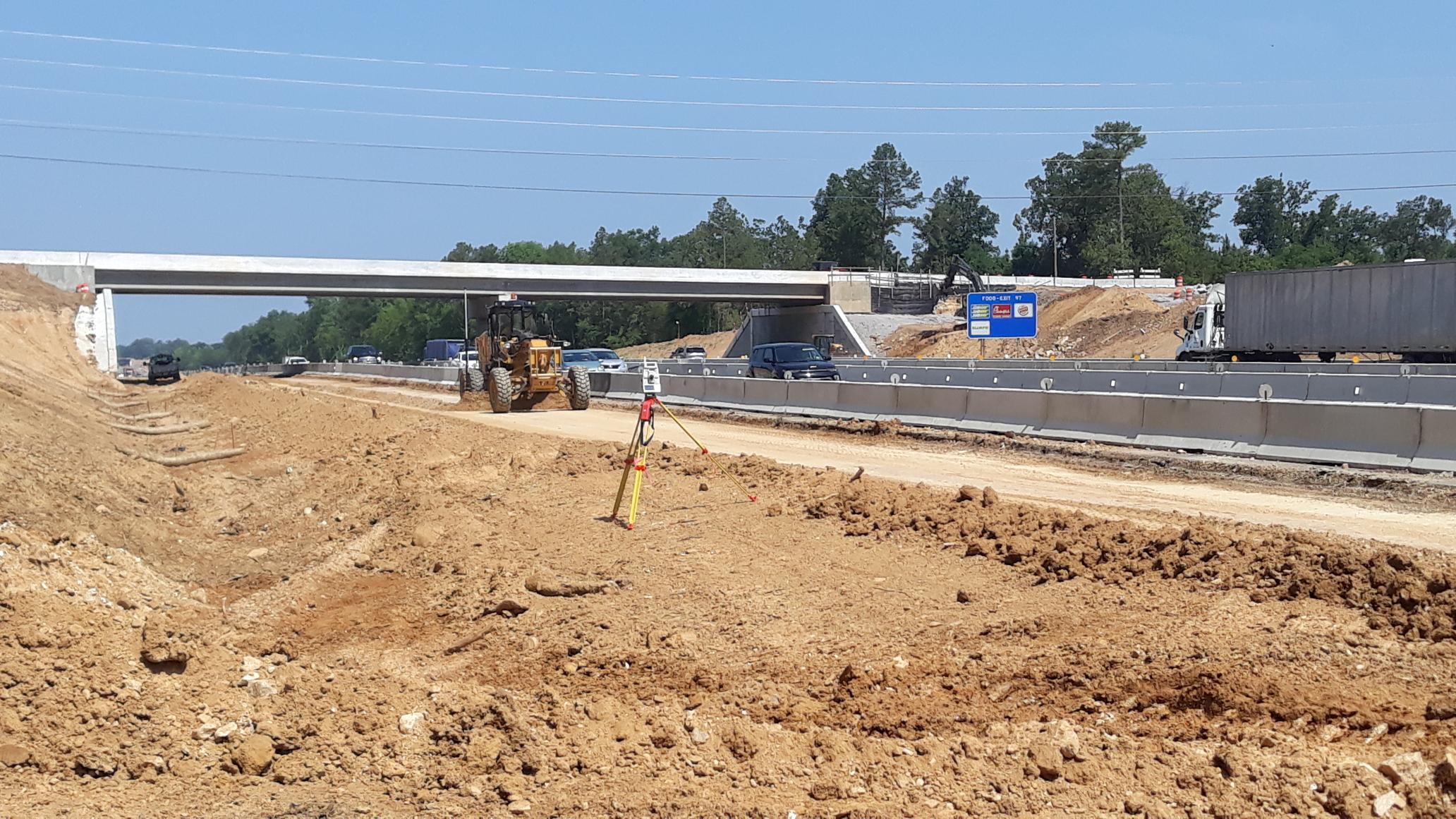 In this photo, the contractor utilizes state of the art surveying equipment to automate the fine grading operation along I-26 near Shady Grove Road.