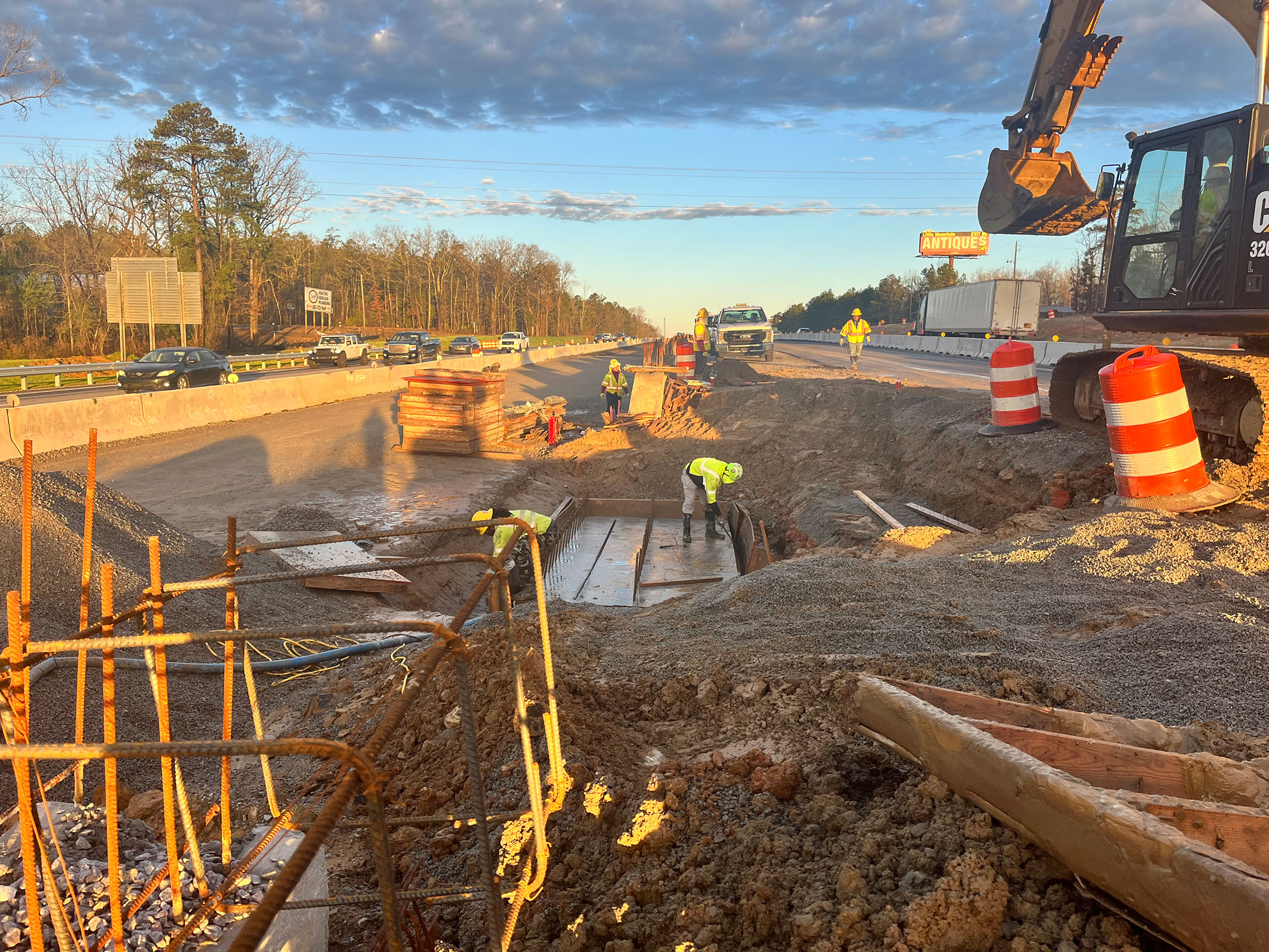 Crews in Segment 1 are removing the formwork for a concrete footing that will be the base for a future overhead sign structure.  Planning and coordination are key elements in highway construction.