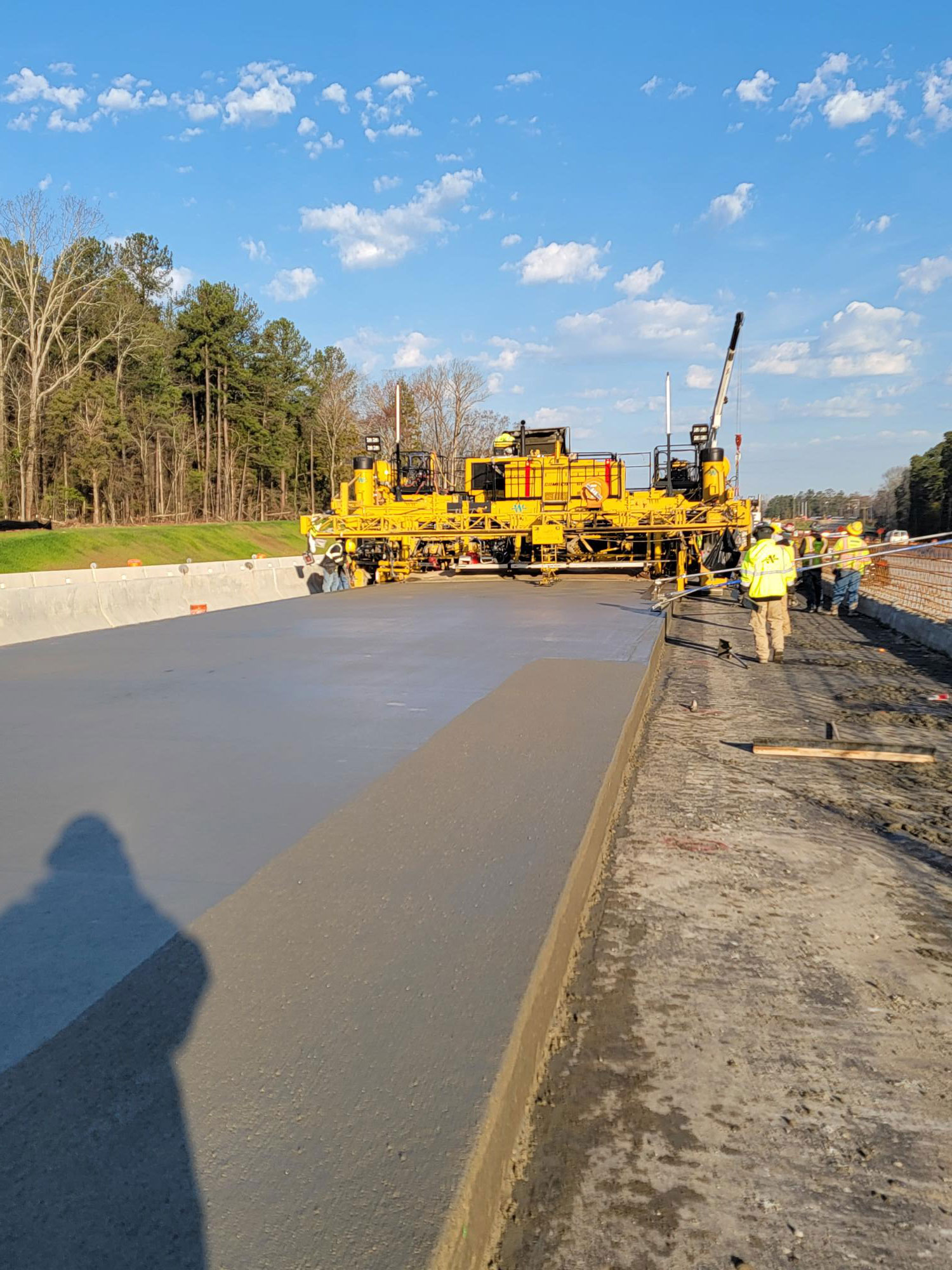 The contractor utilizes a dual lane paver to pave two lanes at a time.  On a good day, over 2,000 CY of concrete can be placed.  That’s more than 200 dump truck loads!